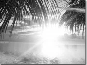 Preview: Glasbild mit Sonnenaufgang über dem Meer in sw